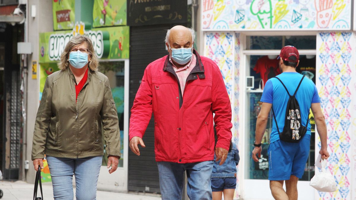 Personas con mascarilla por la calle