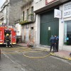 Os bombeiros ventilan un taller onde un vehículo botaba fume