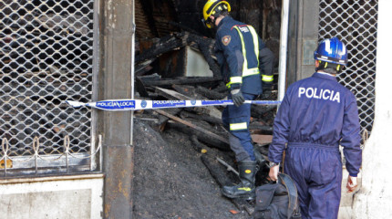 Agentes de la policía científica revisan el edificio incendiado
